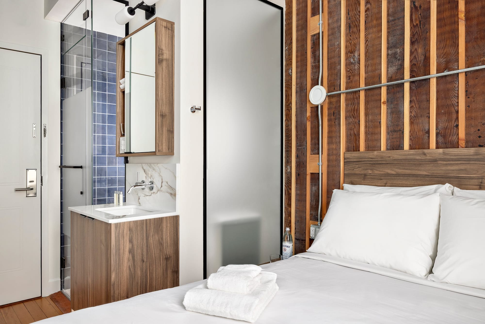 Room detail — bed, walk-in shower and ensuite vanity